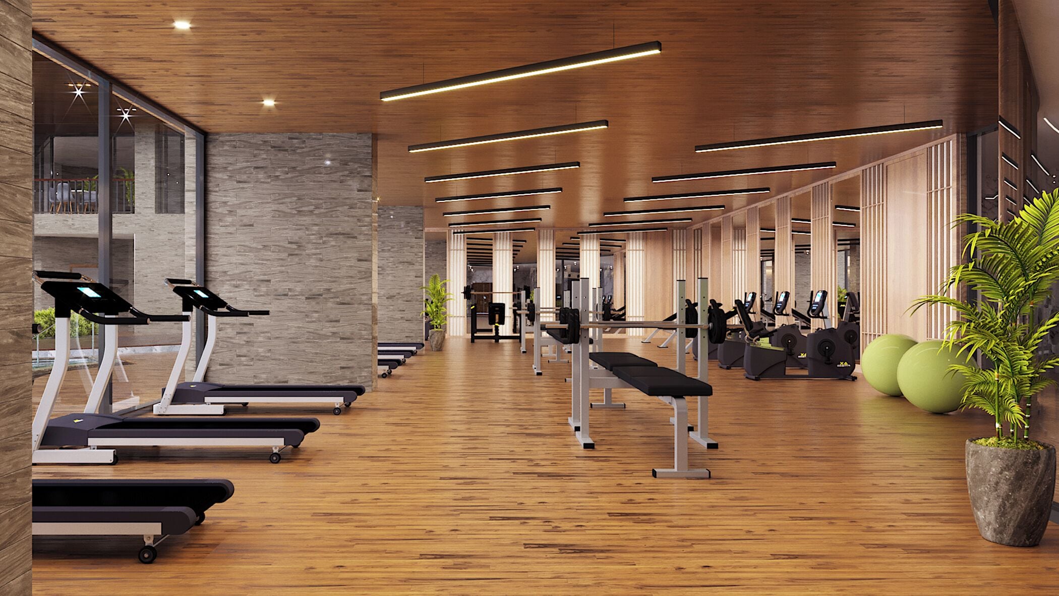 Un gimnasio moderno con cintas de correr, máquinas de pesas y piso de madera.