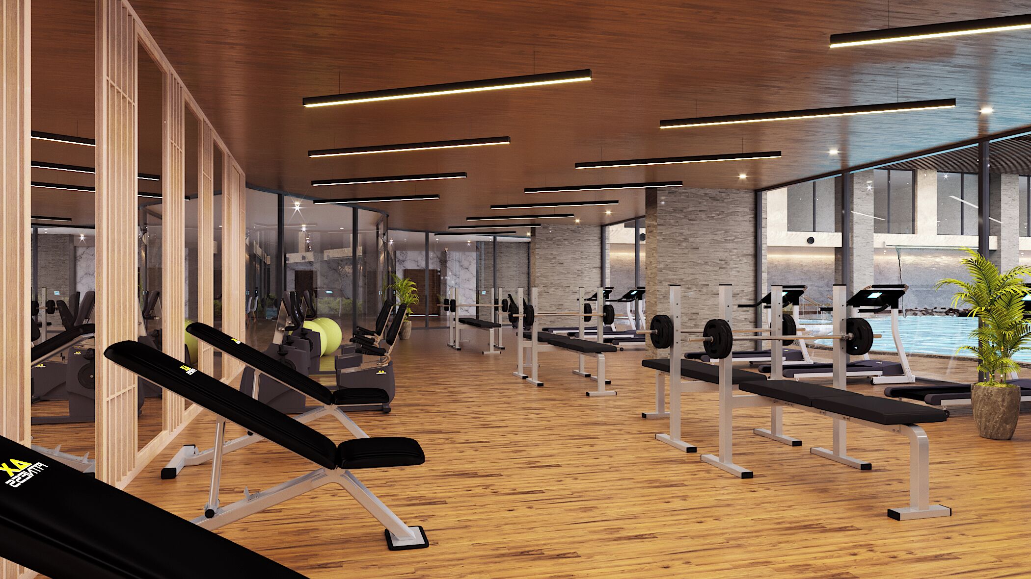 Un gimnasio moderno con pisos de madera, equipamiento de ejercicio y ventanas amplias.