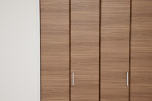 A wooden wardrobe with two handles and a white wall beside it. - Nishi-Sugamo Guest House. 2min to Nishi-Sugamo Sta. 13min to Ikebukuro Sta. (Tokyo)