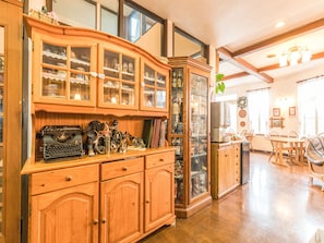 A spacious room with wooden cabinetry, a dining area, and a kitchen.