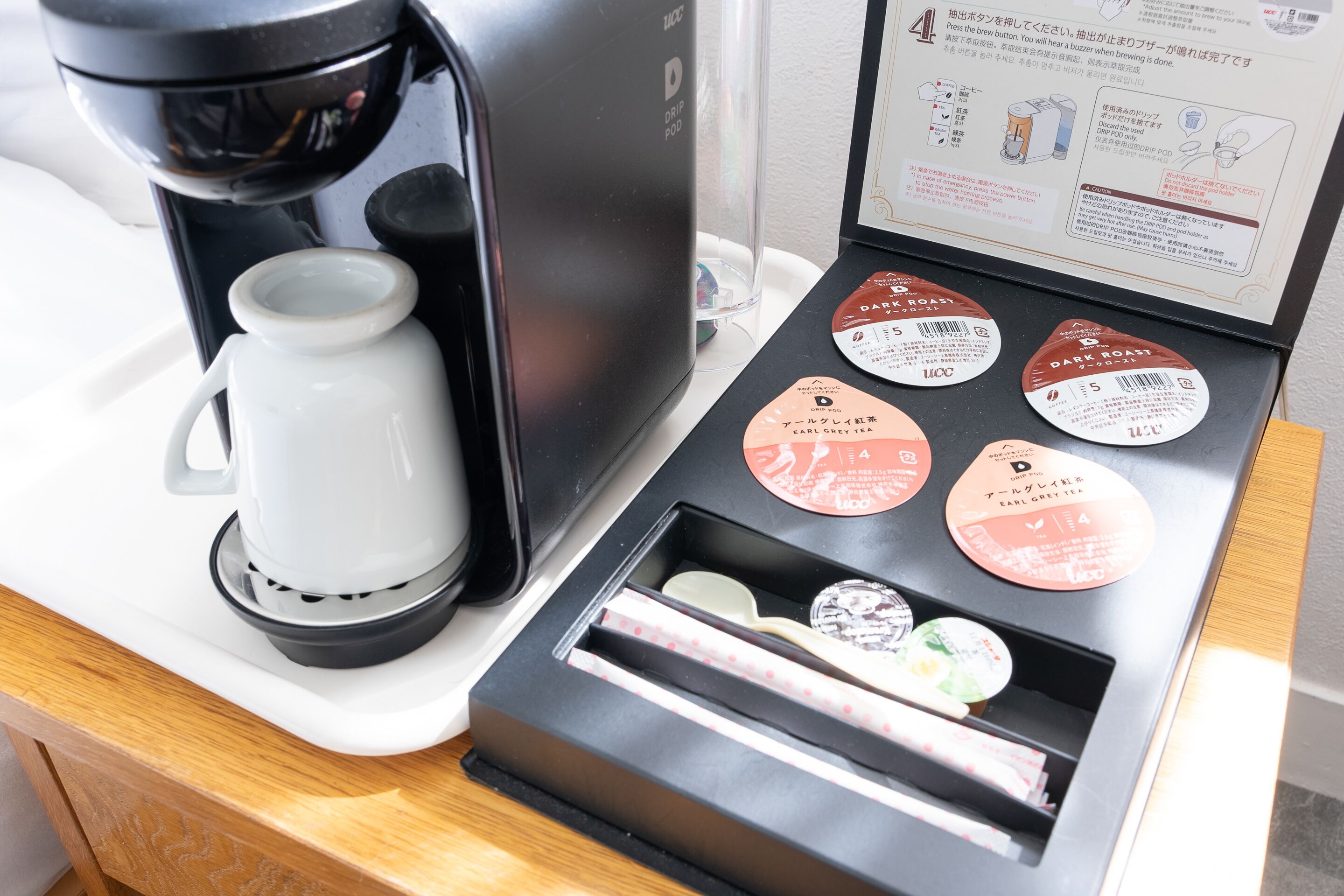 Uma cafeteira e um porta-cápsulas de café com várias cápsulas.