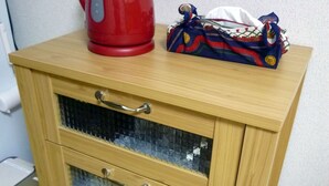 A wooden cabinet with a red kettle and a patterned bag on top. - Free bike and free WIFI 204 Take it easy (Kyoto)