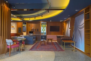 Relax in comfort with a mix of sofas and chairs, a coffee table, and a TV for entertainment.