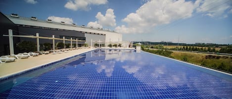 Seasonal outdoor pool, open 10:00 AM to 7:00 PM, pool loungers