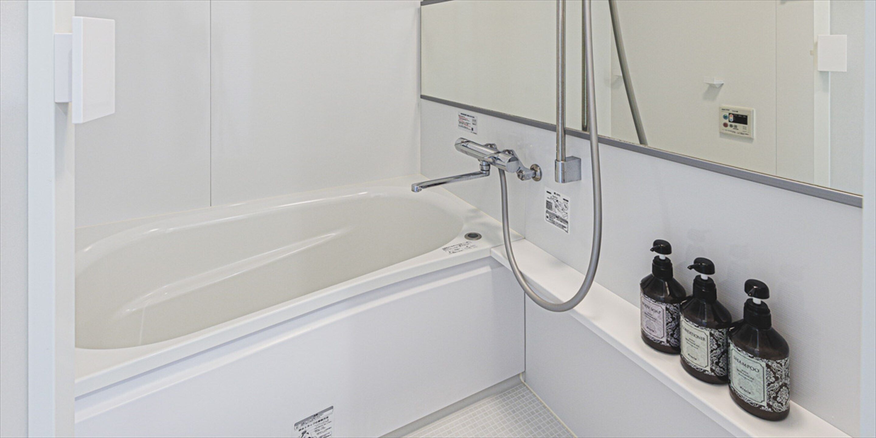 a deluxe | bathroom | free toiletries, hair dryer, slippers, towels