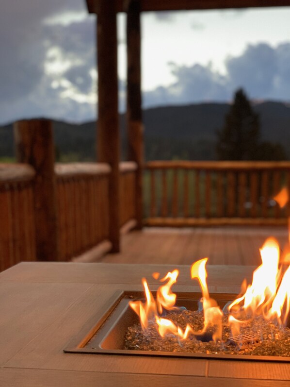 A fire feature with a view of mountains in the background.