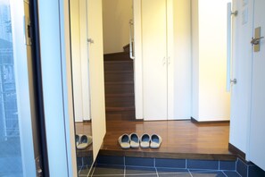 A staircase leading to a landing with a pair of shoes on the steps.