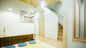 A room with tatami mats, a wooden bench, a mirror, and a staircase. - Oyado Toshi (Kyoto)