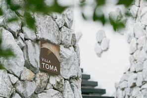 Enter Villa Toma, a charming stone building with a staircase leading up to its entrance.
