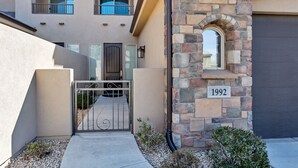A residential building with a stone facade, a gated entrance, and a number plaque indicating '1992'.