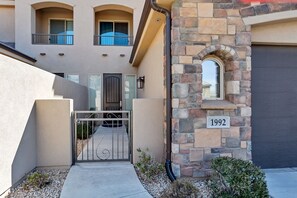 A residential building with a stone facade, a gated entrance, and a number plaque indicating '1992'.