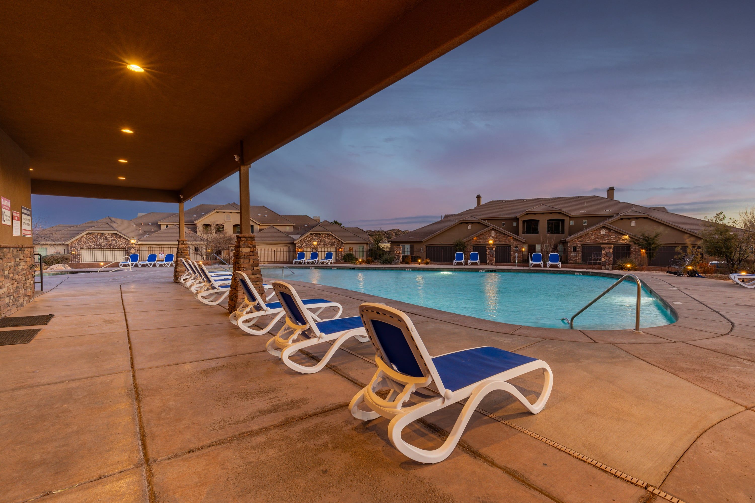 A poolside area with lounge chairs and a swimming pool.