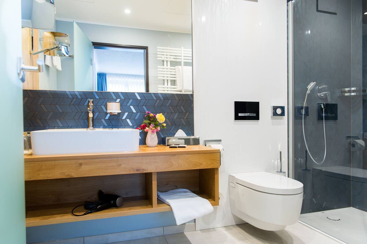 deluxe double room | bathroom | shower, hair dryer, towels, soap