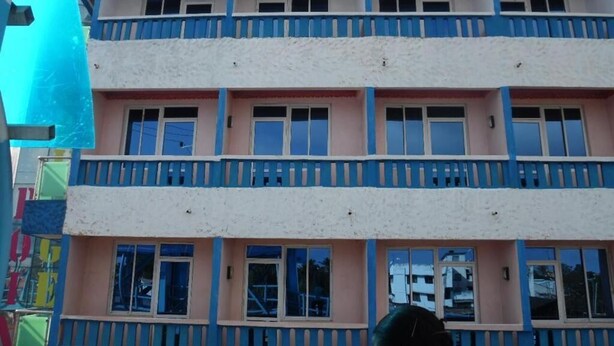 A multi-story building with balconies and windows. - Checkpoint Inn (Mombasa)