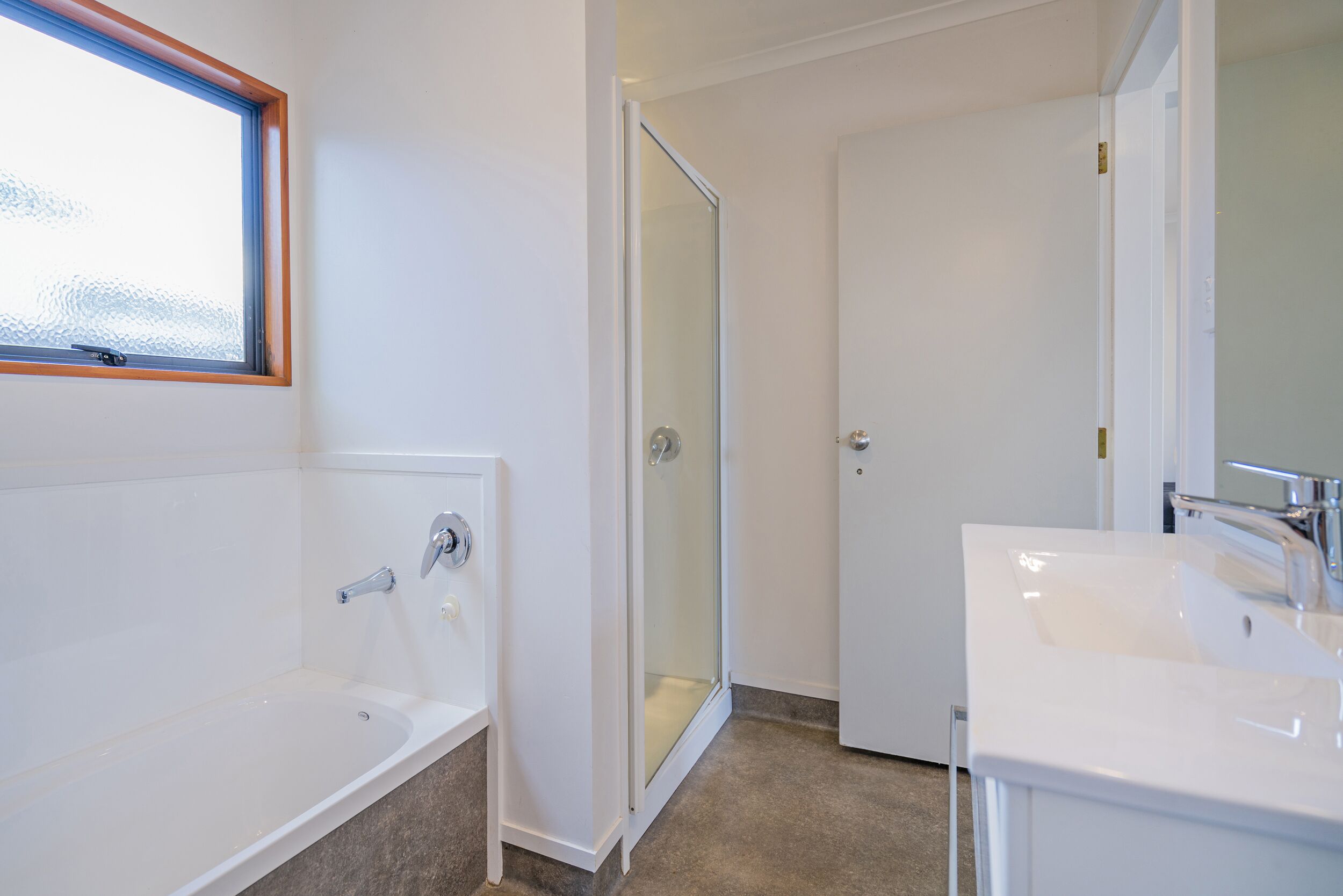 A bathroom with a bathtub, a shower, and a sink.