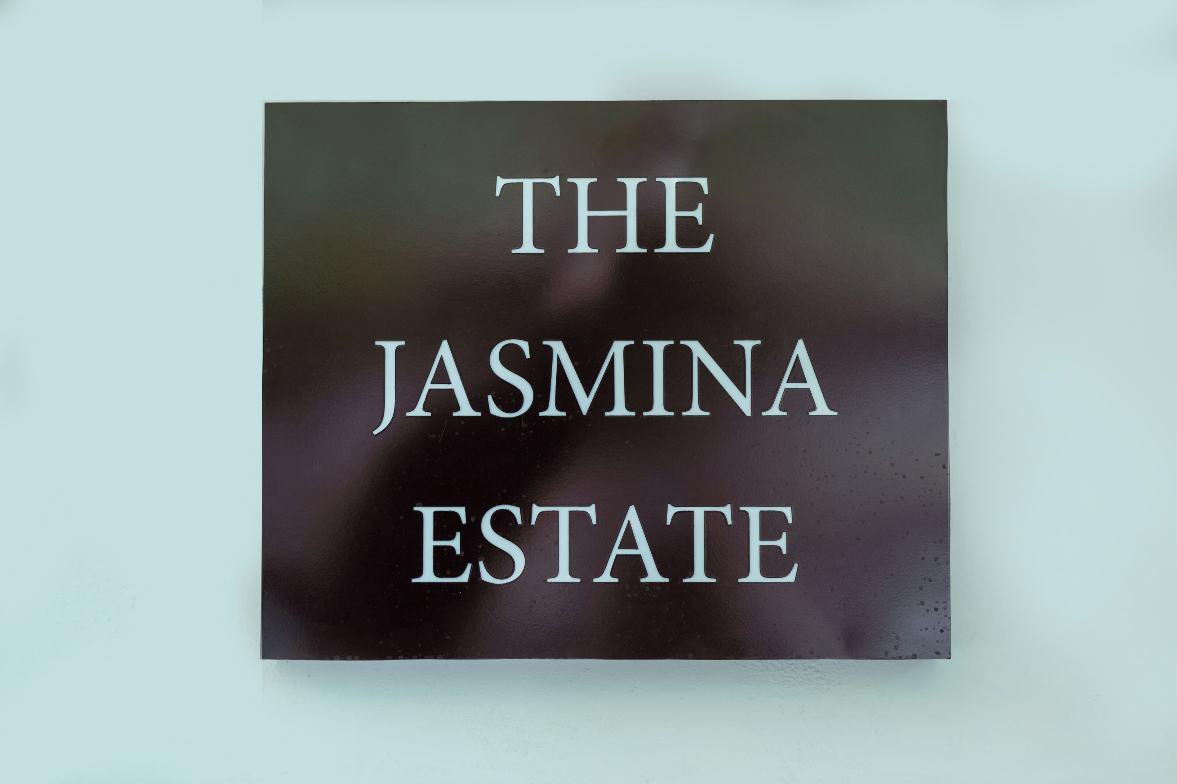 A sign with the text 'THE JASMINA ESTATE'.