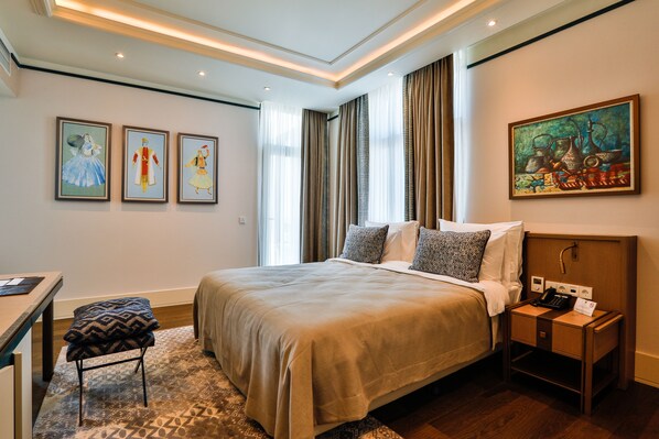 Relax in a stylish room with a comfortable bed, bedside table, and large window with curtains.