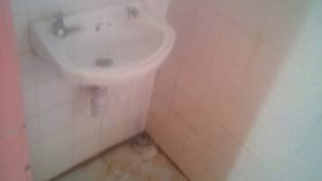 Single Room | Bathroom | Shower, rainfall showerhead, slippers, towels
