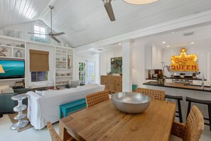 Relax in a well-appointed living space with a dining table, comfortable sofa, and modern appliances.
