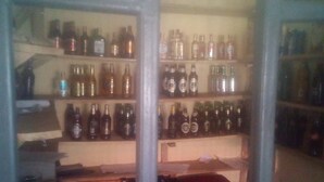 A room with shelves filled with various bottles, likely containing beverages. - Maleck Guest Rooms (Ruiru)