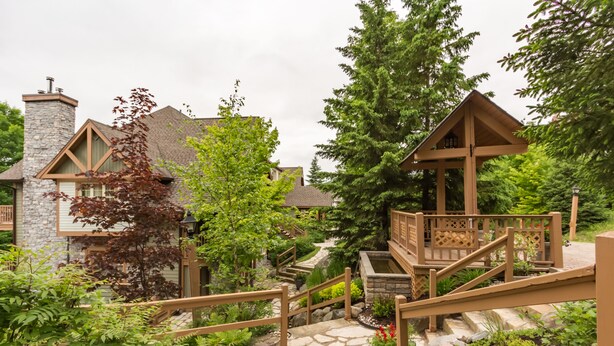 A residential property with a stone staircase, wooden deck, and a gazebo. - Les Falaises by Tremblant Platinum (Mont-Tremblant)