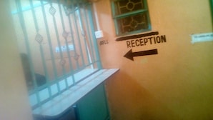 A reception area with a sign indicating the direction to the reception.