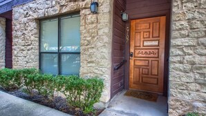 A stone building with a wooden door and a window. - CW C107 Spritzen Haus (New Braunfels)