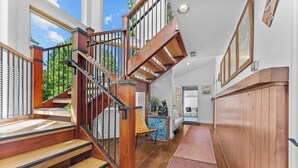 A modern staircase with wooden steps and metal railings, leading to a second floor. - Luxury Lake Tahoe House: Sauna, Gym & Saltwater (Truckee)