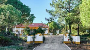 A gated entrance with a pathway leading to a building with a red-tiled roof. - Villa 97 with private pool by Trip2Portugal (Alcácer do Sal)