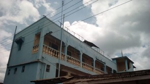 A multi-story building with balconies and a sign for 'TRONIC Lighting Electrical Tools'. - Mombasa Guest House (Kerugoya)