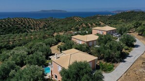 A residential area with two houses, a swimming pool, and a paved path. - Schiza Houses (Pylos-Nestoras)