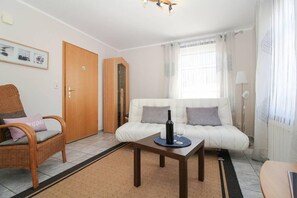 Apartment, 1 Bedroom (Huuske een) | Living area | Flat-screen TV
