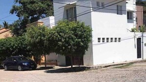 A modern two-story building with a flat roof and a white exterior.