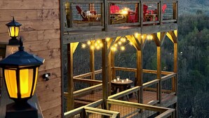 A wooden cabin with a balcony overlooking a mountainous landscape. - MORE THAN A GORGEOUS CABIN, IT'S AN EXPERIENCE!!!!  CLOSE TO ATTRACTIONS & GSM (Sevierville)
