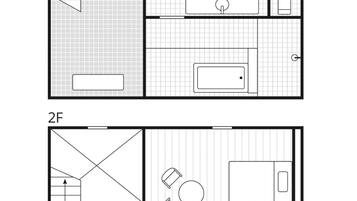 A floor plan of a hotel room with a bathroom, a kitchenette, and a seating area.