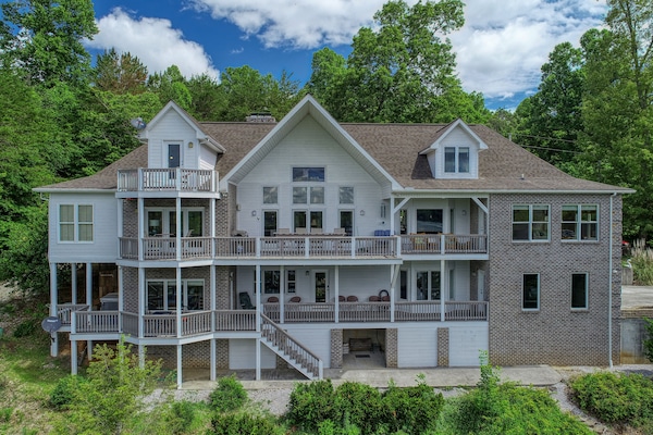 Back of lakefront house 2 covered decks and balcony. Plenty of seating