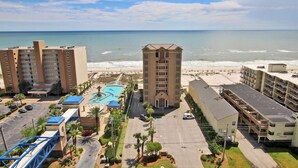 A beachfront hotel with multiple buildings, a swimming pool, and a parking area. - Crystal Tower 1205 by Youngs Suncoast (Gulf Shores)