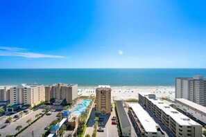 A hotel with a pool, beach view, and parking lot. - Crystal Tower 1809 (Gulf Shores)
