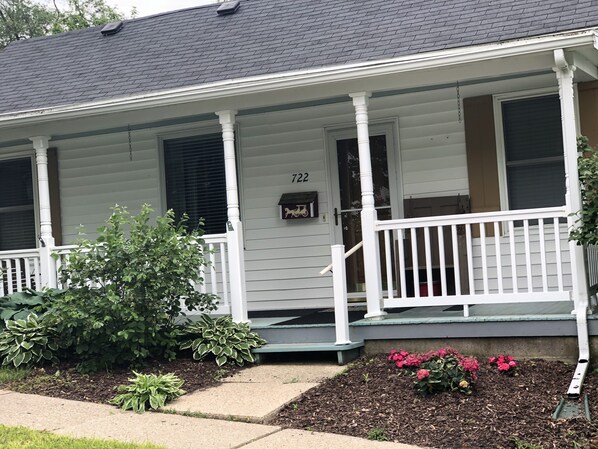 A two-story house with a porch, number 722, and a mailbox.