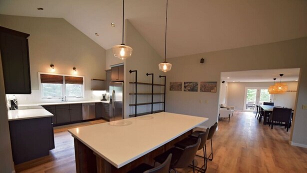 A spacious kitchen with a large island, modern appliances, and pendant lighting. - Spacious and Scenic Mountain Home (Silverthorne)