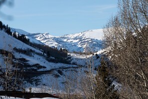 Eine Berglandschaft mit schneebedeckten Hängen und blauem Himmel.