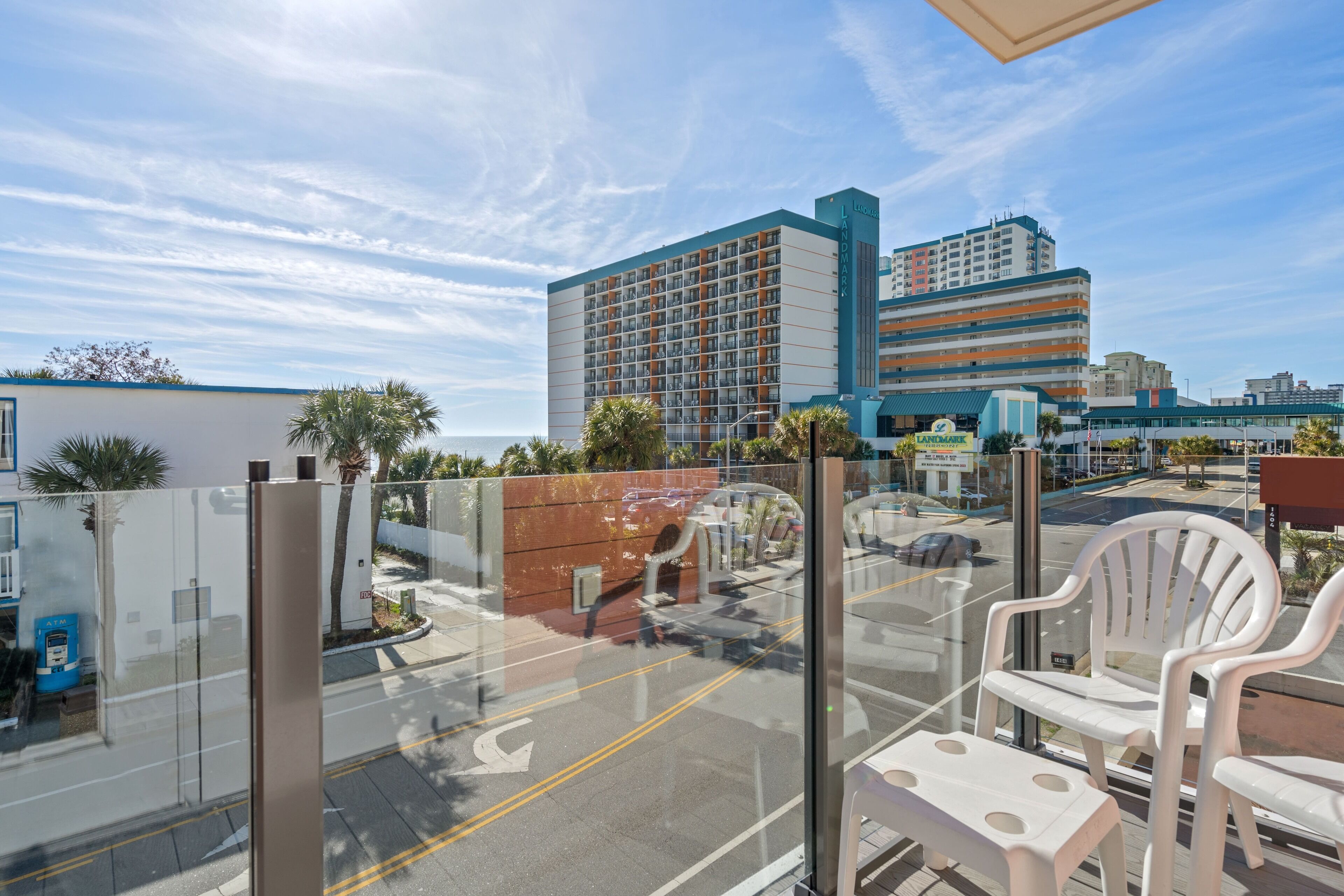 A hotel with a modern design, featuring a large building with multiple floors and a prominent sign.