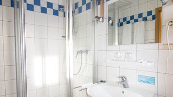 Shower, hair dryer, towels, toilet paper