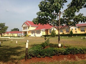 A large, two-story building with a red roof and multiple windows. - Diakonia Resort and Conference Centre (Kadongo)