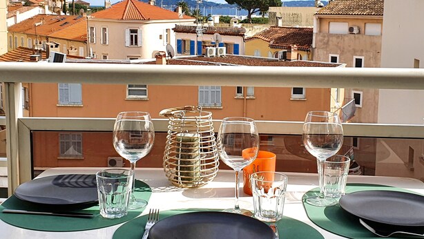 A table set for two with a view of the cityscape.