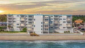 A multi-story hotel with balconies, located near a beach. - Breathtaking Views from this 5th floor Ocean Front Condo  (Satellite Beach)