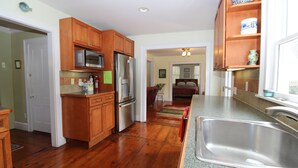 A kitchen with wooden cabinets, stainless steel appliances, and a granite countertop.
