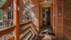 A wooden cabin with a wooden deck and a door leading to an interior room. - MtnScape_Views, EV Charger, GameRoom, Pool Table /PingPong, Arcade +HOA Amenities (Gym/Sauna/Pool) (Truckee)