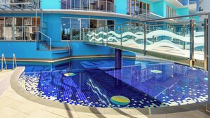 A pool with blue mosaic tiles and a glass bridge. - Kings Beach Top Floor Unit With Private Rooftop (Kings Beach)
