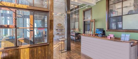 A reception area with wooden paneling, a reception desk, and a chandelier.